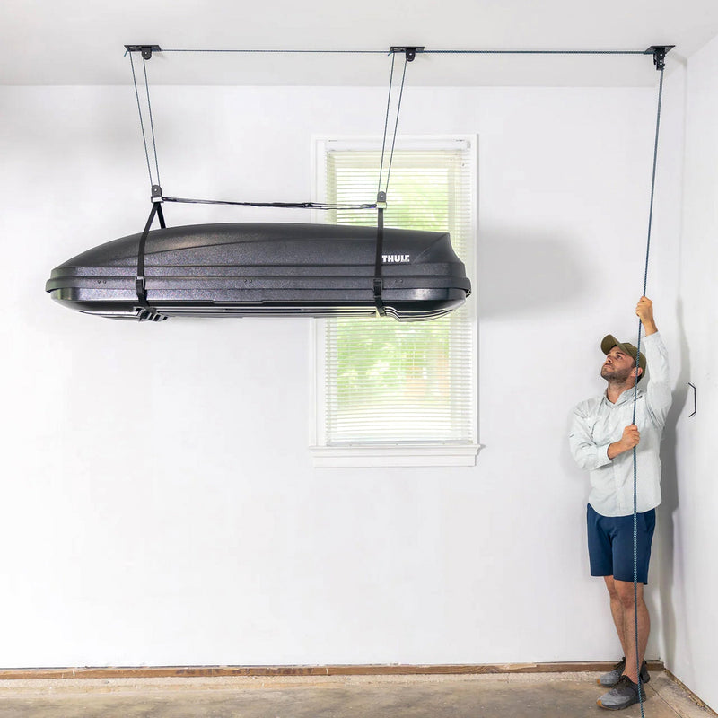 Man raising a rooftop cargo box to the ceiling with the EasyLift hoist
