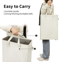 Beige slim laundry hamper carried by its long handles and side grips