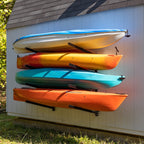 Four kayaks stored on the Shenandoah 4-level rack on a shed wall