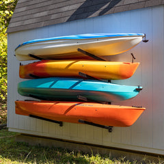 Four kayaks stored on the Shenandoah 4-level rack on a shed wall