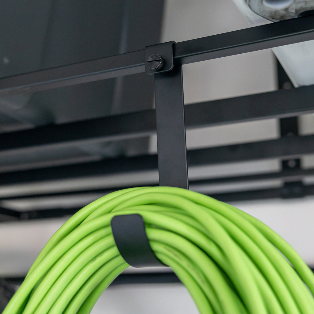 Extension cord hanging on a hook under an overhead ceiling shelf