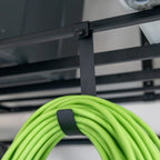 Extension cord hanging on a hook under an overhead ceiling shelf