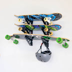 Three skateboards and a helmet stored on the Trifecta wall racks