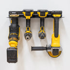 Cordless drills and an angle grinder hanging in the four-slot rack