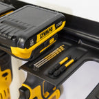 Close-up of a battery and drill bits resting on the organizer rack