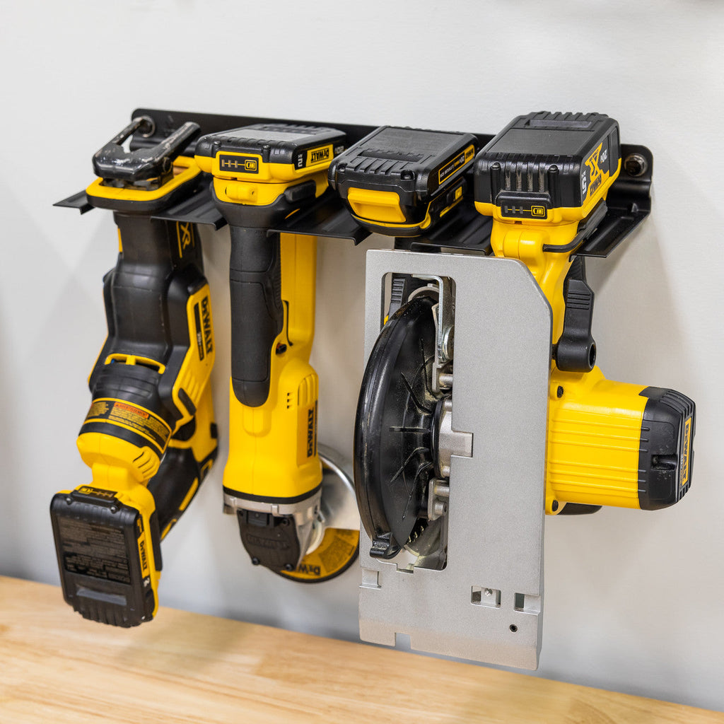 Four-slot power tool organizer holding drills, a grinder and a circular saw