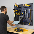 Man taking a paper towel from the pegboard above the workbench