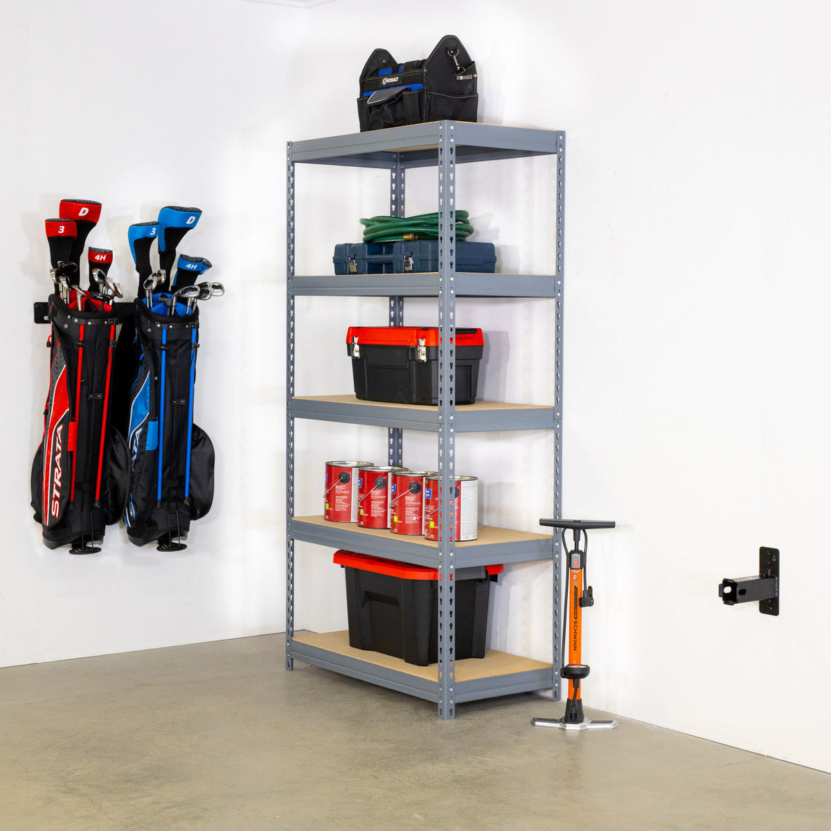 Hitch wall mount installed on a garage wall beside a metal shelving unit