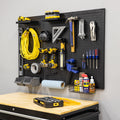 51 x 32 inch pegboard with an extension cord, hand tools, drills, bins and a basket above a workbench