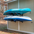 Two kayaks stored on the Shenandoah 2-level rack on an outdoor shed wall