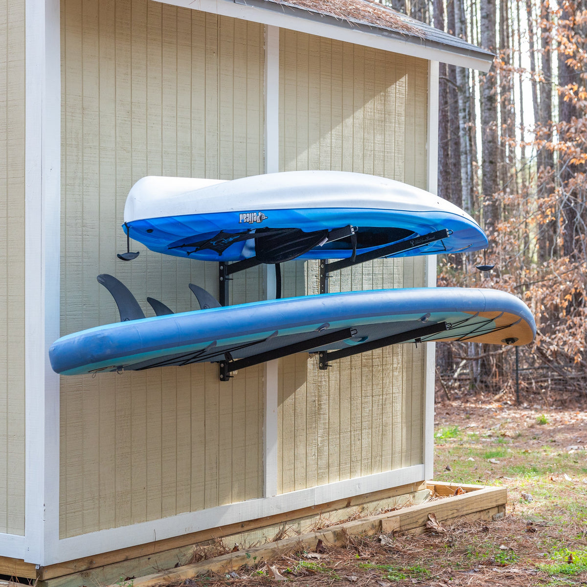 Kayak and paddleboard stored on the shed wall rack