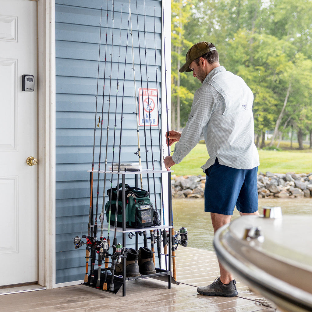 Man using the rod stand beside a boat on a dock