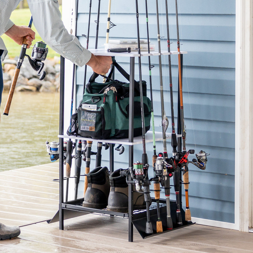 Man taking a rod from the stand holding a tackle bag and boots