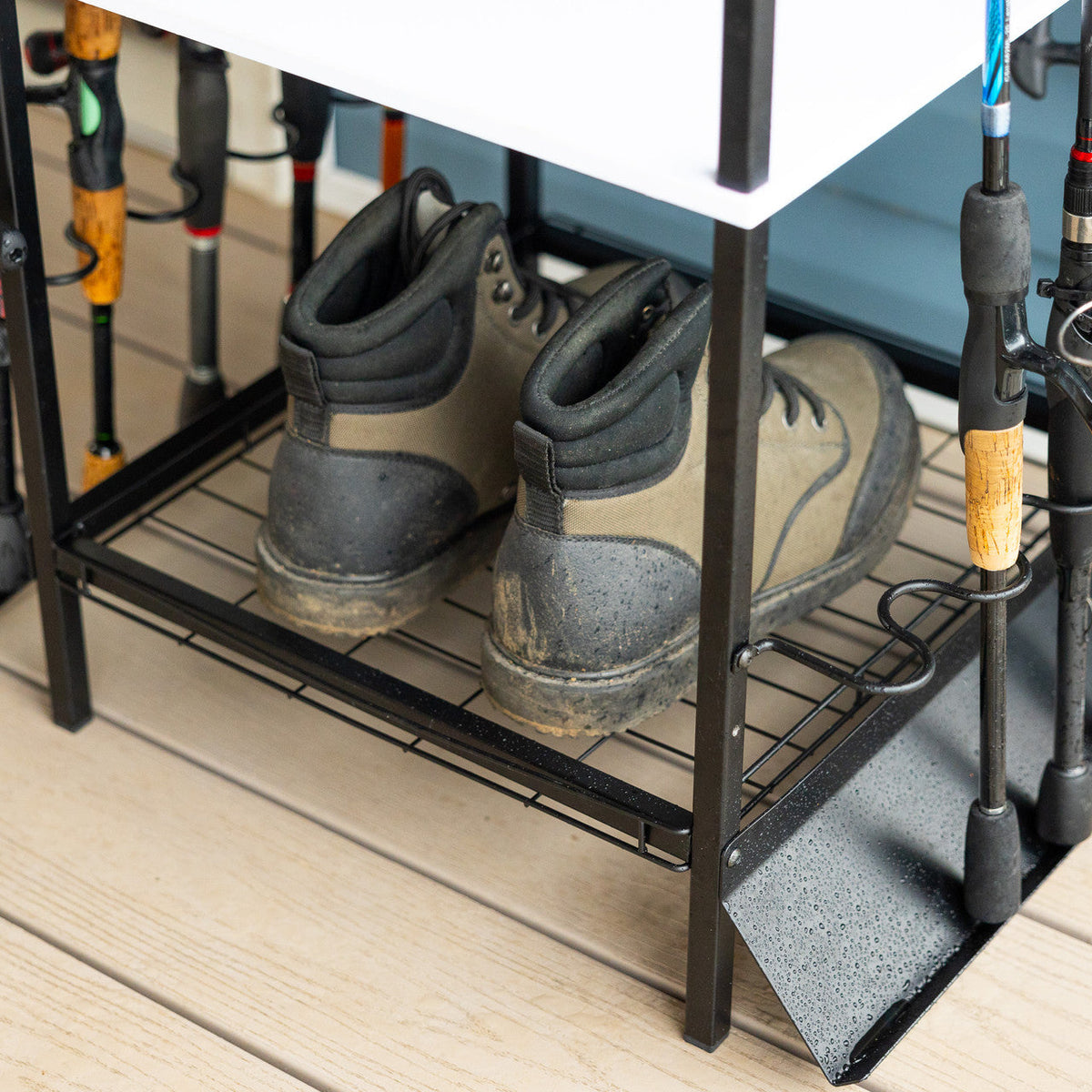 Wading boots on the bottom rack of the rod stand