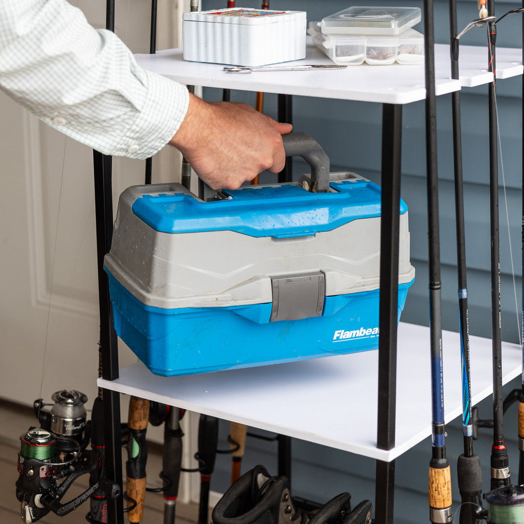 Hand placing a tackle box on the rod stand shelf