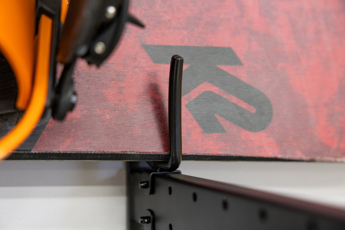 Close-up of a snowboard edge on the organizer hook