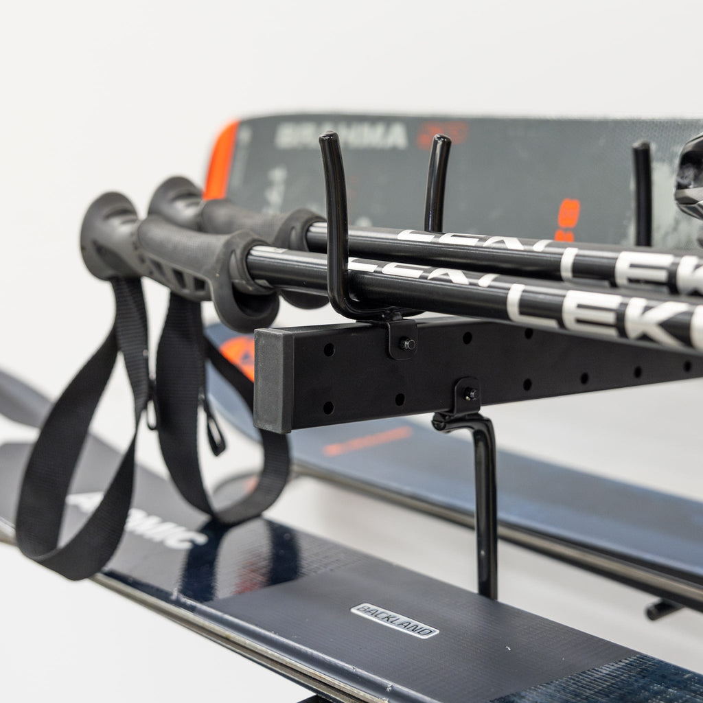 Close-up of ski poles and skis resting on the organizer arms