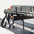 Close-up of ski poles and skis resting on the organizer arms