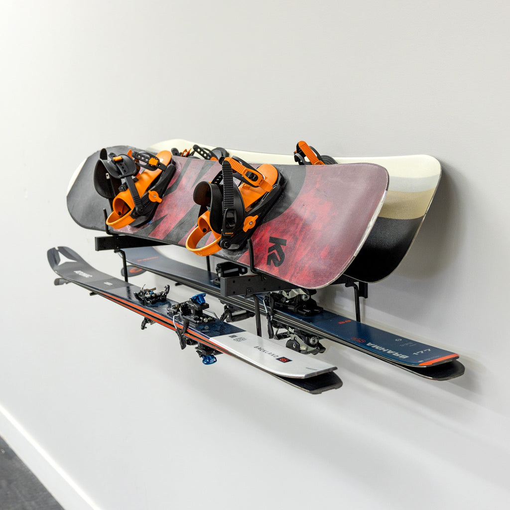 Two snowboards and skis stored on the Cascade wall organizer