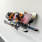 Two snowboards and skis stored on the Cascade wall organizer
