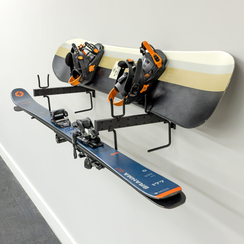 Snowboard and skis on the wall organizer, angled view