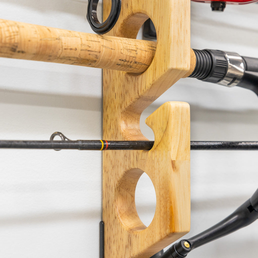 Close-up of a rod handle resting in a wood rack slot