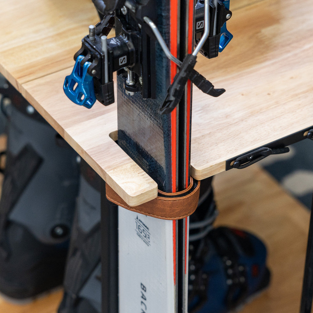 Close-up of skis held by leather straps on the Silverton rack