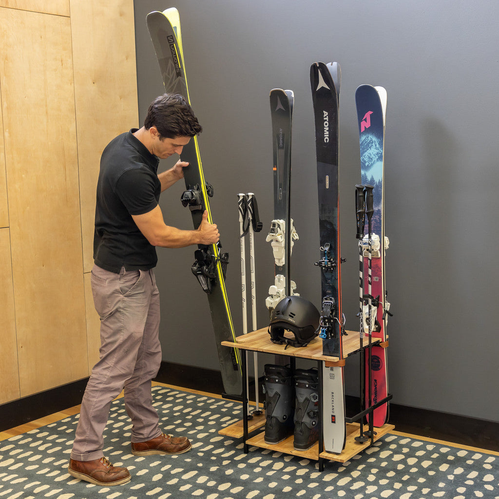 Man placing skis in the Silverton ski rack