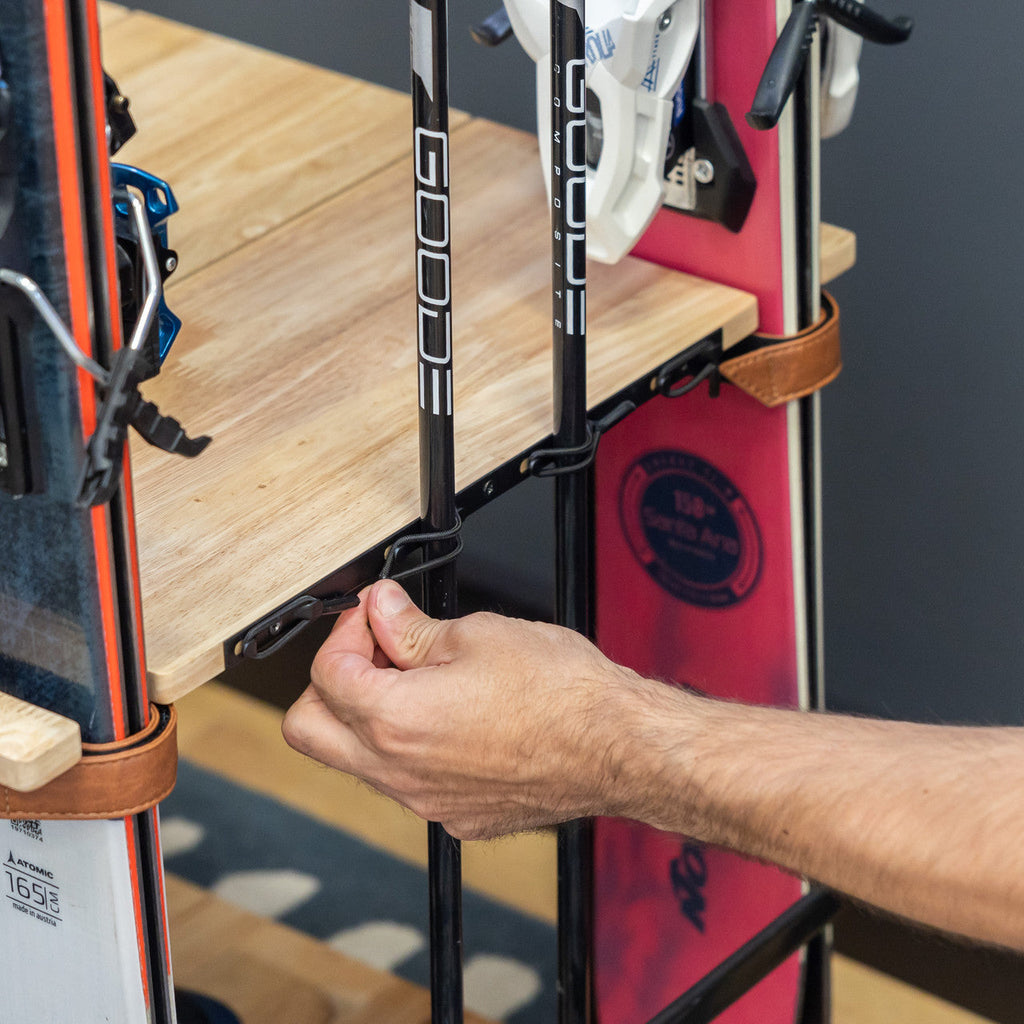 Hand fastening a ski in the Silverton rack strap