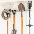 Hose, rake, shovels and a string trimmer hung on the gray organizer