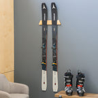 Pair of skis displayed on the Vail wood rack above ski boots