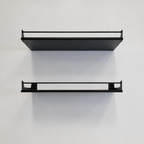 Two empty black Haven steel wall shelves with guard rails