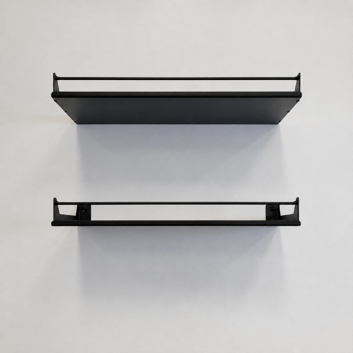 Two empty black Haven steel wall shelves with guard rails