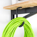 Close-up of an extension cord hanging on the DIY bracket hook