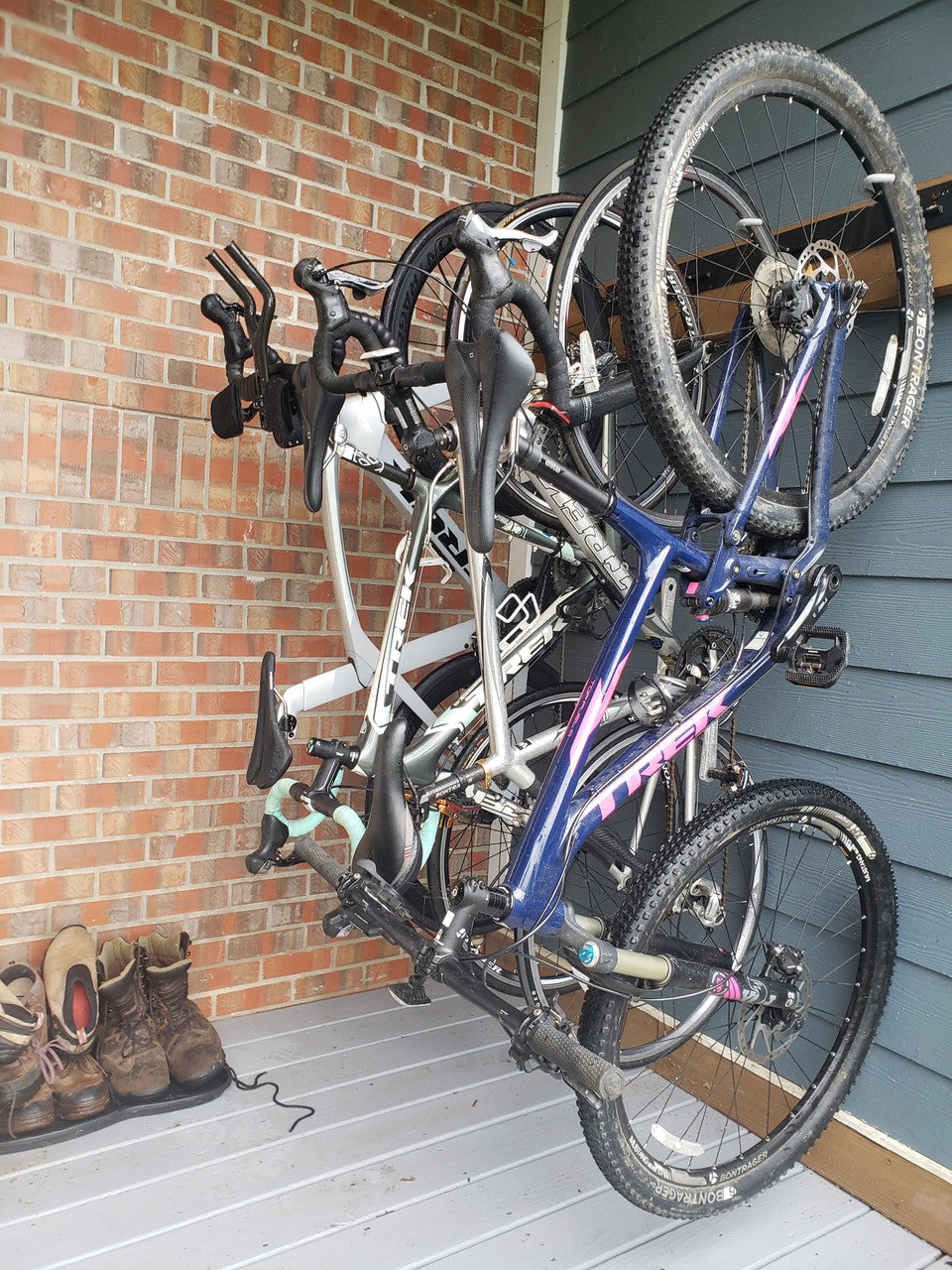 Several bikes hanging on a Blackstone rack in a narrow storage space