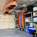 Kayaks stored overhead on the Hi-Port 2 ceiling rack in a garage