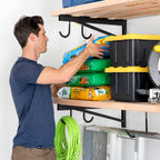 Man placing a bag of potting mix on a DIY bracket shelf