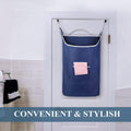 Navy laundry hamper hanging behind a bathroom door