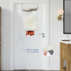 Beige over-the-door hamper unloading clothes through its bottom zipper