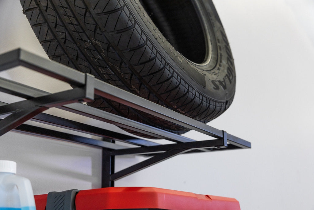 Close-up of a tire stored on a black wall shelf