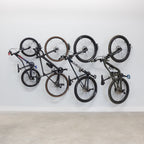 Four bikes hanging on swivel wall hooks