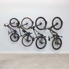 Four bikes hanging on swivel wall hooks