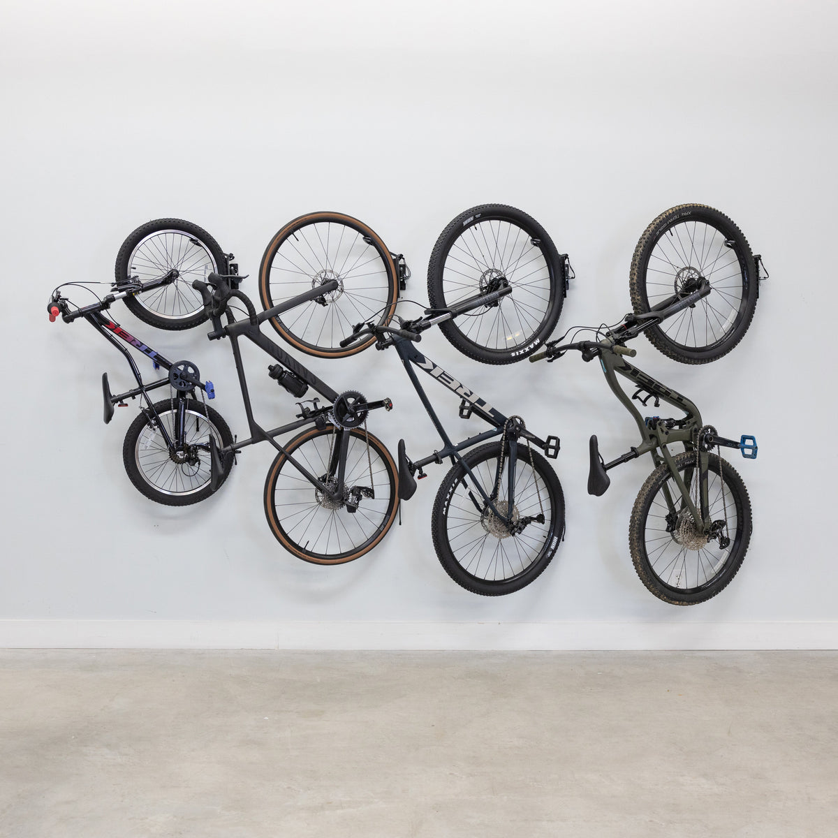 Four bikes hanging on swivel wall hooks