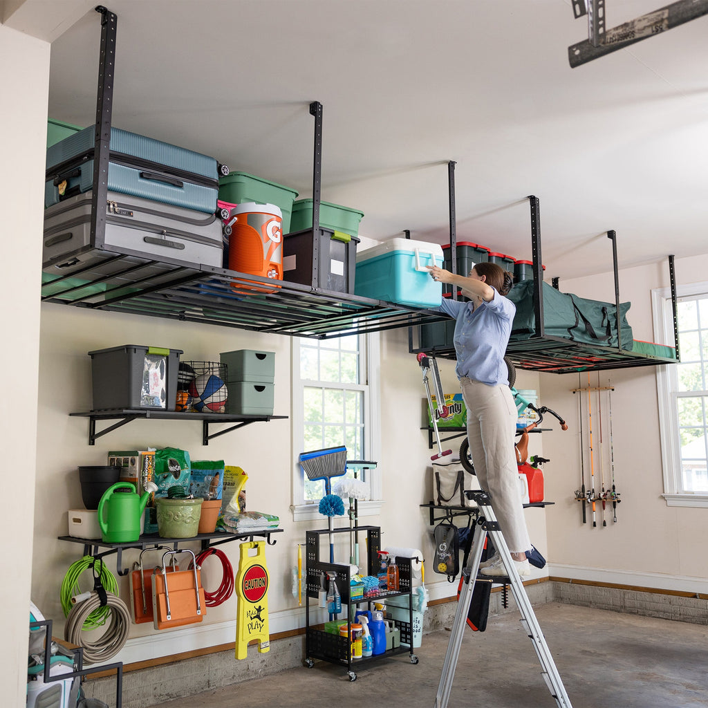 Garage with overhead racks full of bins above wall storage and sports gear