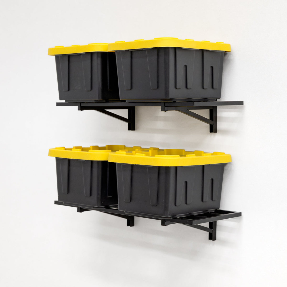 Two black wall shelves each holding two storage totes