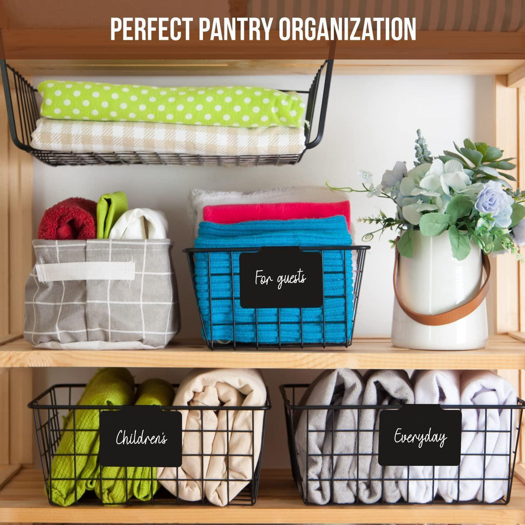 Reusable black clip-on labels on wire baskets organizing guest, children’s, and everyday towels
