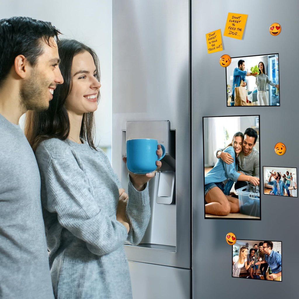 Black magnetic sleeves displaying family photographs on a refrigerator