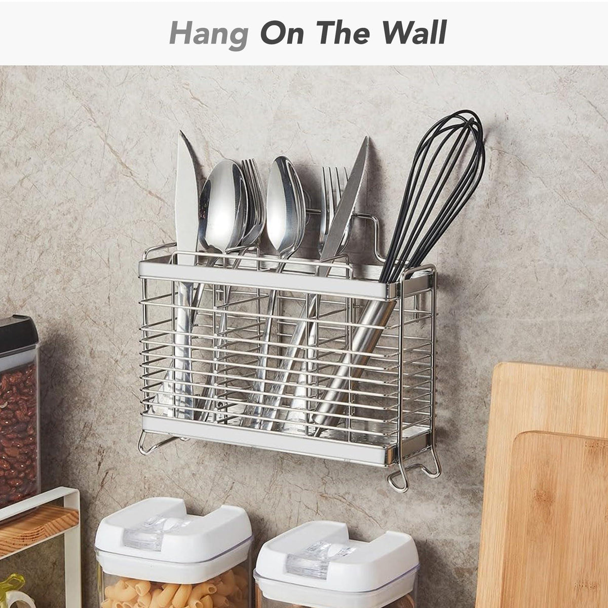 Steel utensil organizer mounted on a kitchen wall above storage jars