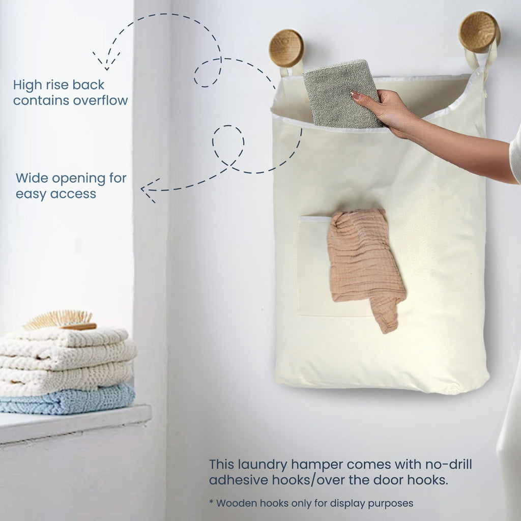 Wide opening, high back, and front pocket of a beige hanging laundry hamper