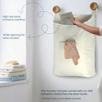 Wide opening, high back, and front pocket of a beige hanging laundry hamper